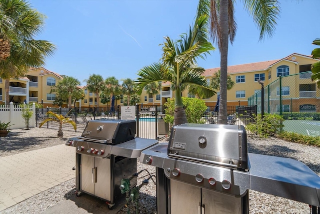 10764 70th Ave Unit 4305, Seminole, FL 33772 - view of patio / terrace featuring a grill and a residential view