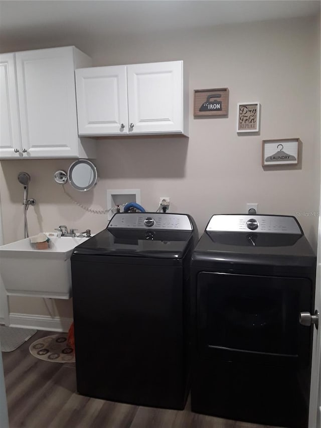 702 Cypress Pl, Sun City Center, FL 33573 - laundry room with separate washer and dryer, cabinet space, and wood finished floors
