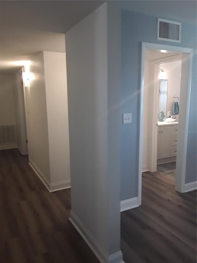 702 Cypress Pl, Sun City Center, FL 33573 - hallway featuring dark wood finished floors and baseboards