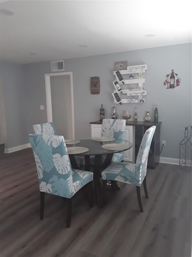 702 Cypress Pl, Sun City Center, FL 33573 - dining area with dark wood-type flooring and baseboards