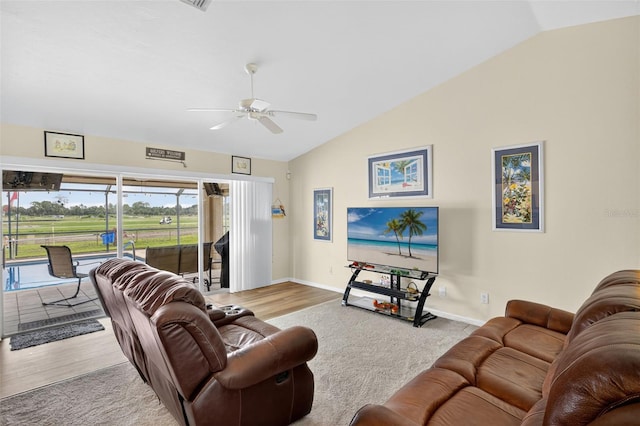 125 Paddock St, Lehigh Acres, FL 33974 - living area featuring lofted ceiling, a ceiling fan, and wood finished floors
