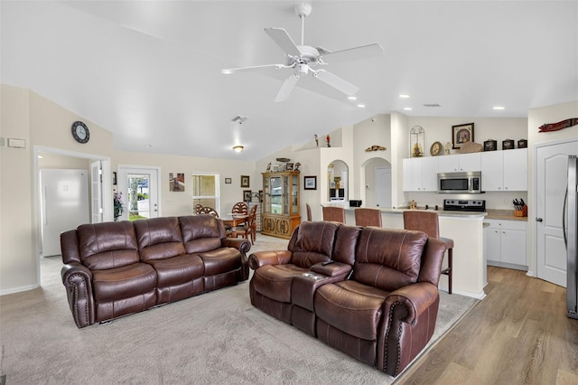 125 Paddock St, Lehigh Acres, FL 33974 - living room featuring a ceiling fan, recessed lighting, high vaulted ceiling, arched walkways, and light wood-style floors
