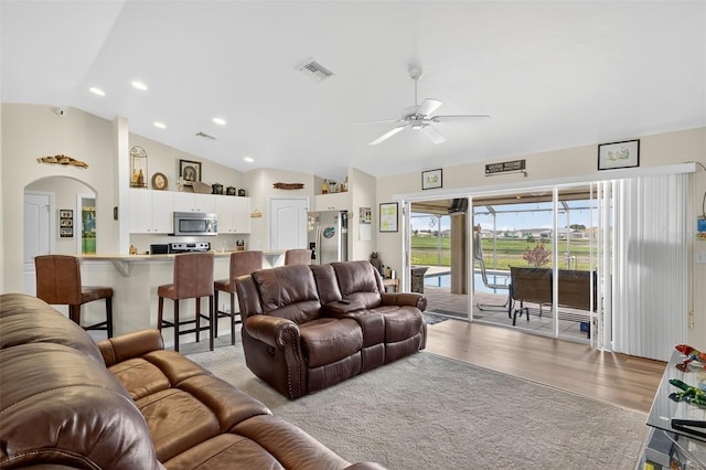 125 Paddock St, Lehigh Acres, FL 33974 - living area with vaulted ceiling, light wood-style flooring, a ceiling fan, recessed lighting, and arched walkways