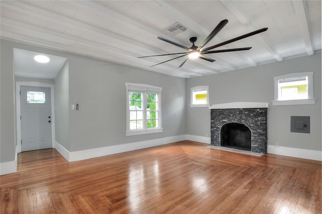 720 Woodward St, Lakeland, FL 33803 - unfurnished living room with a ceiling fan, a fireplace with flush hearth, beam ceiling, and light wood-type flooring