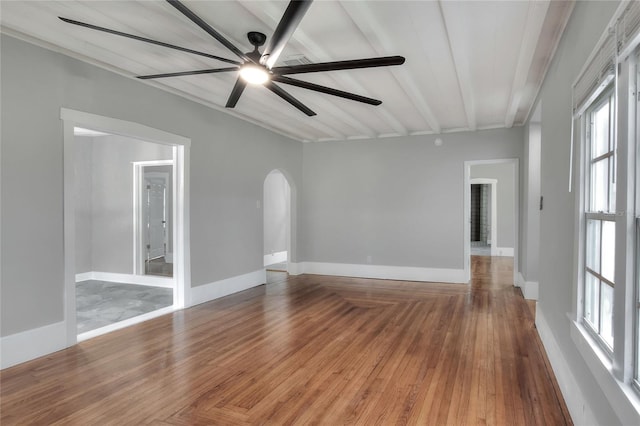 720 Woodward St, Lakeland, FL 33803 - unfurnished room with arched walkways, a ceiling fan, plenty of natural light, and wood finished floors