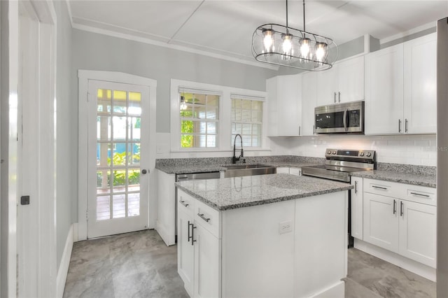 720 Woodward St, Lakeland, FL 33803 - kitchen with stainless steel microwave, a center island, and white cabinetry