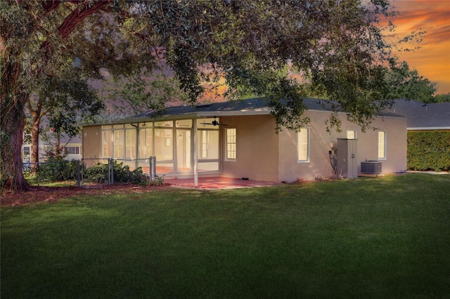 720 Woodward St, Lakeland, FL 33803 - view of front of house with a ceiling fan, a sunroom, stucco siding, and a patio area