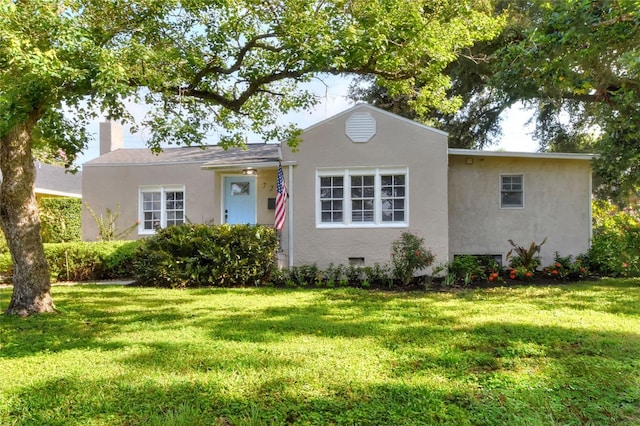 720 Woodward St, Lakeland, FL 33803 - view of front of house with a front lawn, stucco siding, and a chimney