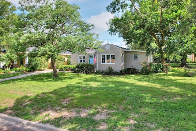 720 Woodward St, Lakeland, FL 33803 - ranch-style house featuring a front lawn, stucco siding, and driveway