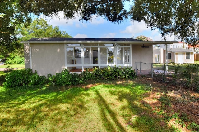 720 Woodward St, Lakeland, FL 33803 - back of property with a ceiling fan, stucco siding, a gate, and a sunroom