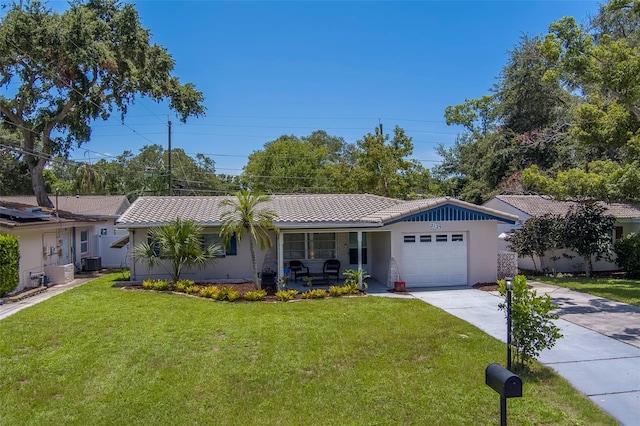 2123 Indigo Dr, Clearwater, FL 33763 - ranch-style home with concrete driveway, covered porch, a front lawn, and a tile roof