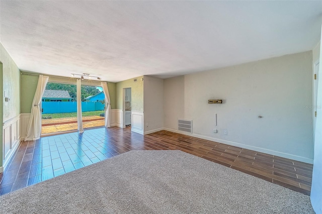 2123 Indigo Dr, Clearwater, FL 33763 - unfurnished room featuring wood tiled floors, wainscoting, and a decorative wall