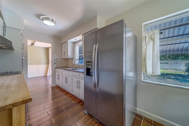 2123 Indigo Dr, Clearwater, FL 33763 - kitchen with stainless steel fridge, dark wood-type flooring, decorative backsplash, and dark countertops