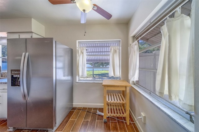 2123 Indigo Dr, Clearwater, FL 33763 - kitchen with stainless steel fridge, wood finished floors, plenty of natural light, and a ceiling fan
