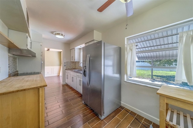 2123 Indigo Dr, Clearwater, FL 33763 - kitchen with stainless steel refrigerator with ice dispenser, ceiling fan, dark wood-type flooring, backsplash, and white cabinets