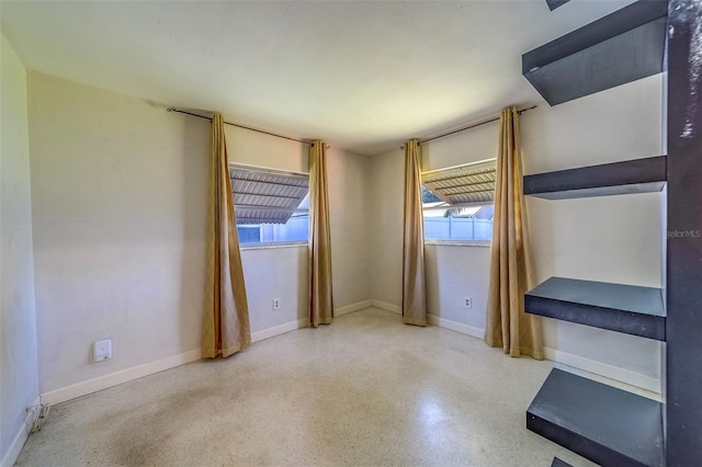 2123 Indigo Dr, Clearwater, FL 33763 - unfurnished room featuring baseboards and speckle patterned floor