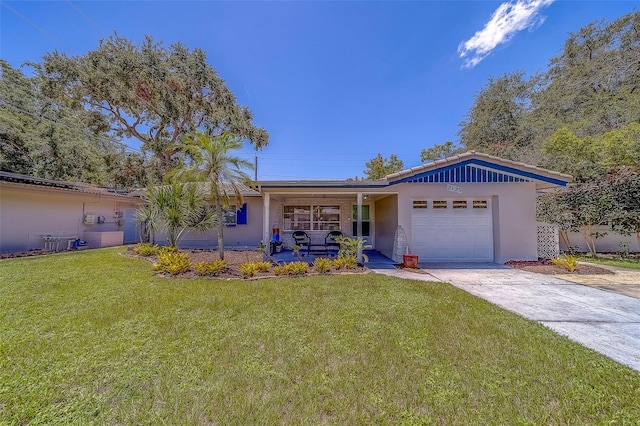 2123 Indigo Dr, Clearwater, FL 33763 - single story home featuring a garage, driveway, a front lawn, and stucco siding