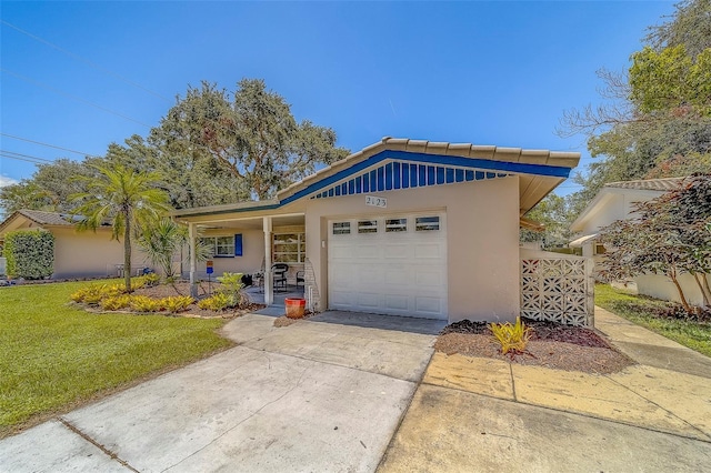 2123 Indigo Dr, Clearwater, FL 33763 - view of front of property with stucco siding, a garage, driveway, and a front lawn