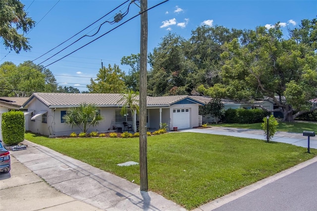 2123 Indigo Dr, Clearwater, FL 33763 - ranch-style home featuring a tiled roof, an attached garage, stucco siding, a front lawn, and driveway