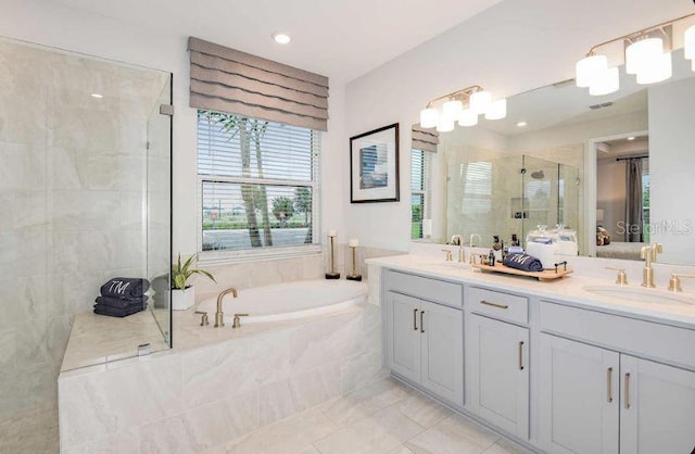 33618 Castaway Loop, Wesley Chapel, FL 33543 - bathroom with a stall shower, a garden tub, double vanity, ensuite bathroom, and recessed lighting