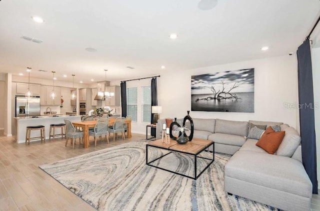33618 Castaway Loop, Wesley Chapel, FL 33543 - living area with light wood-style floors and recessed lighting