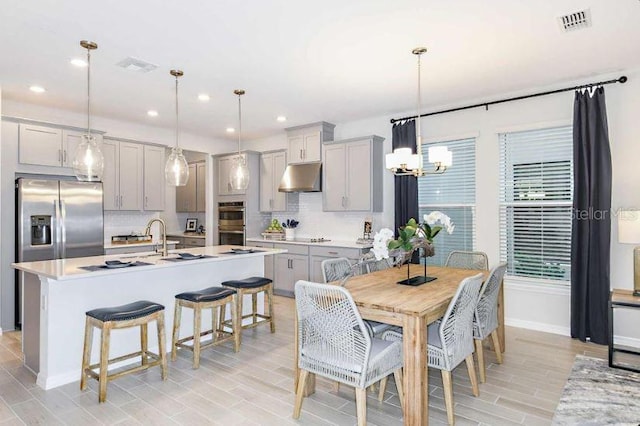 33618 Castaway Loop, Wesley Chapel, FL 33543 - dining area with a chandelier, wood tiled floors, and recessed lighting