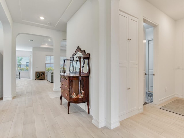 6057 Marsh Trail Dr, Odessa, FL 33556 - hall with arched walkways, light wood-style flooring, and recessed lighting