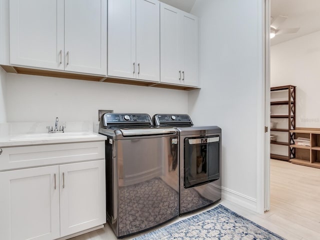 6057 Marsh Trail Dr, Odessa, FL 33556 - washroom with separate washer and dryer, cabinet space, and light wood finished floors