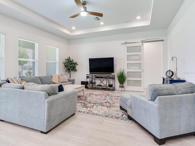 6057 Marsh Trail Dr, Odessa, FL 33556 - living room featuring ceiling fan, a tray ceiling, recessed lighting, and a barn door