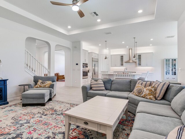 6057 Marsh Trail Dr, Odessa, FL 33556 - living area featuring a ceiling fan, recessed lighting, a raised ceiling, and arched walkways