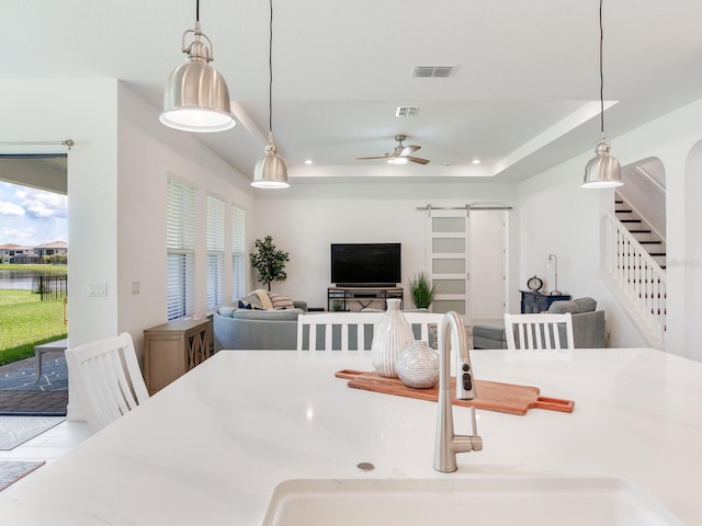 6057 Marsh Trail Dr, Odessa, FL 33556 - dining area featuring stairway, ceiling fan, a raised ceiling, and a water view