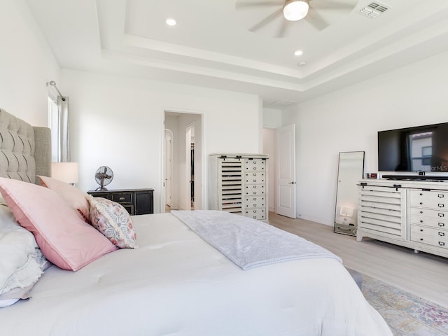 6057 Marsh Trail Dr, Odessa, FL 33556 - bedroom with a tray ceiling, wood finished floors, recessed lighting, and a ceiling fan