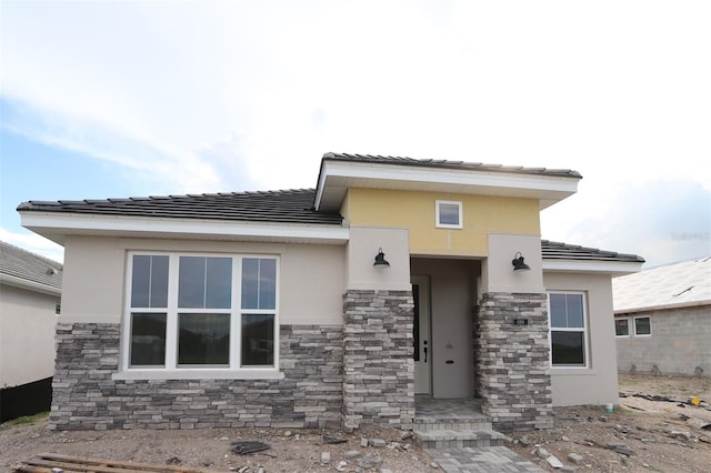 699 Allora Ave, Nokomis, FL 34275 - view of front of home with stucco siding, stone siding, and a tiled roof