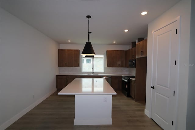 699 Allora Ave, Nokomis, FL 34275 - kitchen with appliances with stainless steel finishes, a kitchen island, recessed lighting, decorative backsplash, and dark wood-style flooring