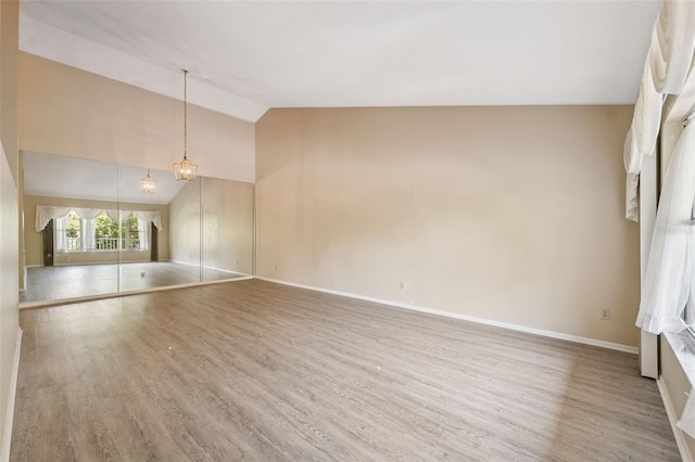 2192 Swedish Dr Unit 26, Clearwater, FL 33763 - spare room with wood finished floors and high vaulted ceiling