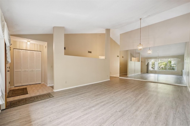 2192 Swedish Dr Unit 26, Clearwater, FL 33763 - unfurnished living room featuring wood finished floors and high vaulted ceiling