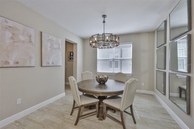 2866 Quail Crest Ct, Valrico, FL 33594 - dining area featuring a chandelier and light wood-type flooring