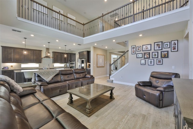 2866 Quail Crest Ct, Valrico, FL 33594 - living room featuring a towering ceiling, stairs, light wood-style flooring, and recessed lighting