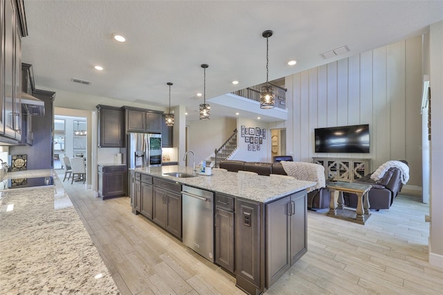 2866 Quail Crest Ct, Valrico, FL 33594 - kitchen with appliances with stainless steel finishes, open floor plan, dark brown cabinetry, light wood finished floors, and recessed lighting
