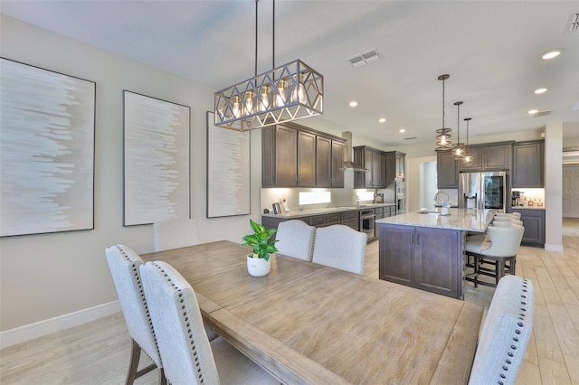 2866 Quail Crest Ct, Valrico, FL 33594 - dining room with light wood finished floors, recessed lighting, and a chandelier