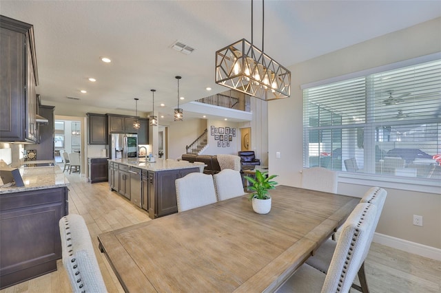 2866 Quail Crest Ct, Valrico, FL 33594 - dining area with stairs, light wood-style flooring, recessed lighting, and a chandelier