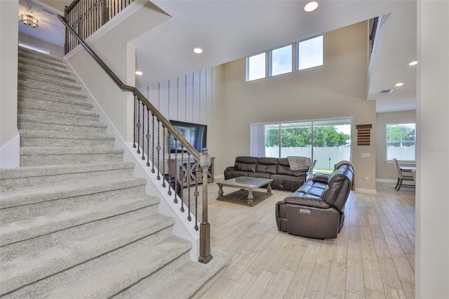 2866 Quail Crest Ct, Valrico, FL 33594 - living room with a high ceiling, stairs, wood finished floors, and recessed lighting