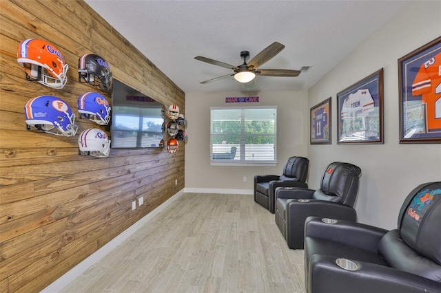 2866 Quail Crest Ct, Valrico, FL 33594 - sitting room featuring wood walls, ceiling fan, wood finished floors, and a textured ceiling
