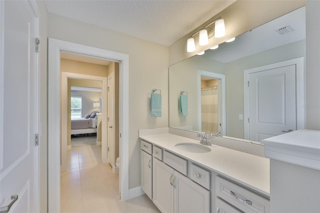2866 Quail Crest Ct, Valrico, FL 33594 - bathroom with vanity, tile patterned flooring, and ensuite bathroom