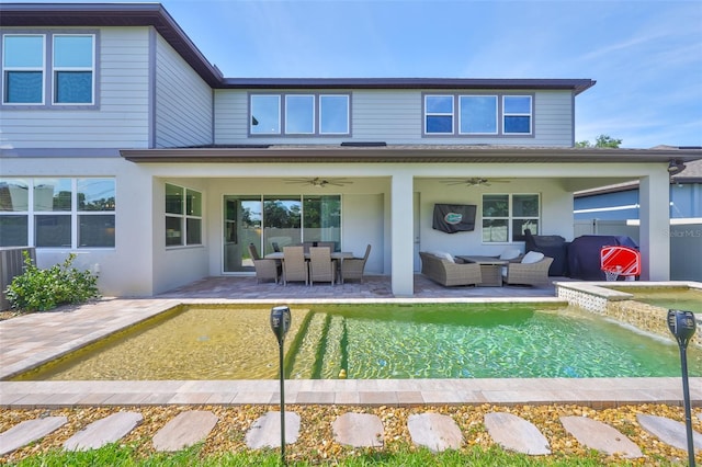 2866 Quail Crest Ct, Valrico, FL 33594 - rear view of house with ceiling fan, outdoor lounge area, a patio area, a pool with connected hot tub, and stucco siding