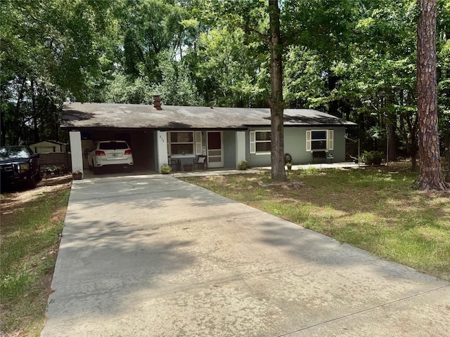 612 NW 9th Cir, Williston, FL 32696 - ranch-style house featuring concrete driveway, a carport, and a front lawn