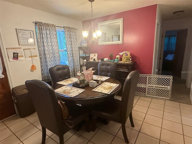 612 NW 9th Cir, Williston, FL 32696 - dining area featuring a chandelier, light tile patterned floors, and a textured ceiling