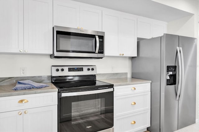 602 Lime Ave Unit 102, Clearwater, FL 33756 - kitchen with appliances with stainless steel finishes, white cabinetry, and light countertops