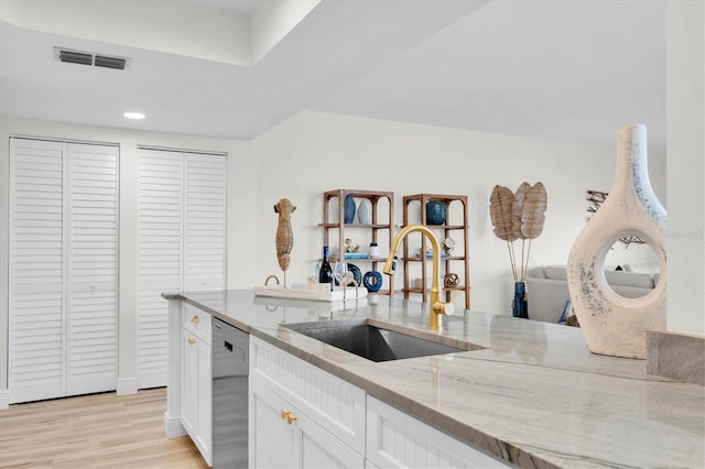 602 Lime Ave Unit 102, Clearwater, FL 33756 - kitchen featuring stainless steel dishwasher, light stone counters, white cabinetry, light wood-style flooring, and recessed lighting