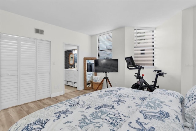 602 Lime Ave Unit 102, Clearwater, FL 33756 - bedroom with wood finished floors and connected bathroom